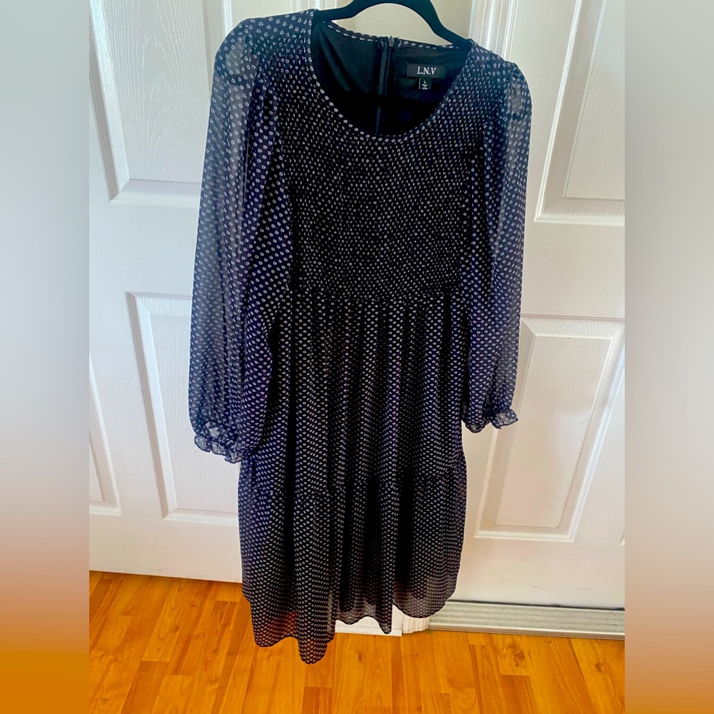 Dress Women’s size Large . Black background with delicate open white dots.